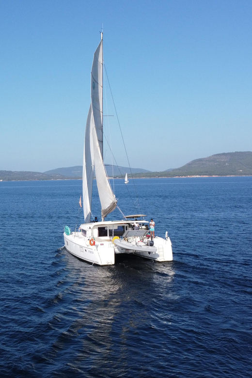 Alghero catamaran sunset tour Alghero - The aperitif stop: local products, Sardinian white wine, and real relaxation