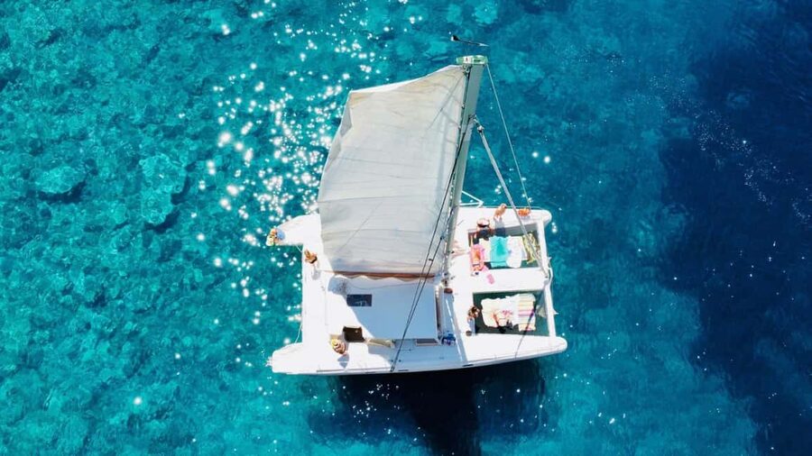 Porto Conte: Half-day catamaran tour with aperitif - Capo Caccia views: close coast, scents of the maquis, and a good skipper