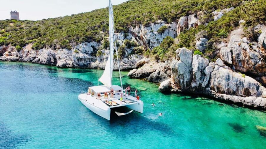 Porto Conte: Half-day catamaran tour with aperitif - The aperitif: sausage, pecorino, and white wine on the water