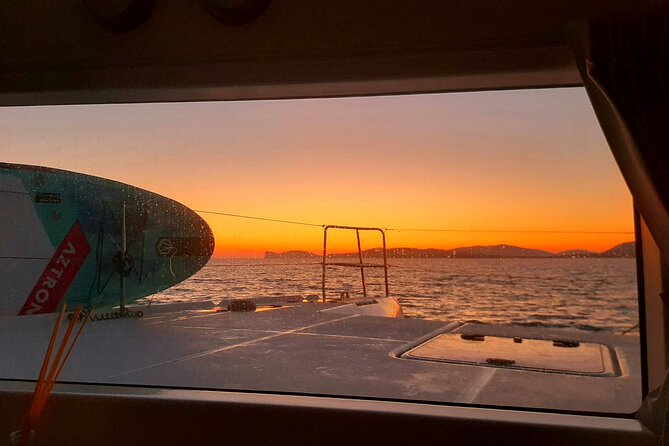 unique aperitif experience at sunset on a catamaran - Sailing Out Past Alghero’s Medieval Walls to Maddalenetta Lighthouse